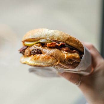 Killer Burger Medford - a hand holding a sandwich - Burgers Near Me - Medford, Oregon Killer Burger Medford - a hand holding a sandwich - Burgers Near Me - Medford, Oregon