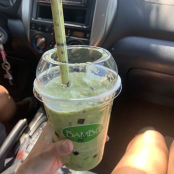 BAMBU - #5 Smashed Avocado - A green smoothie with tapioca pearls in a clear plastic cup with a straw, held by a person inside a vehicle. - Bubble Tea Near Me - Tracy, California
