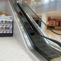 Escalator up across from down escalator.