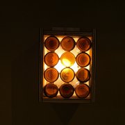 Photo of Cause - The PhilanthroPub - Washington, DC, United States. Decorative light fixture consists of repurposed beer bottles. Nice touch. Beneficial reuse.