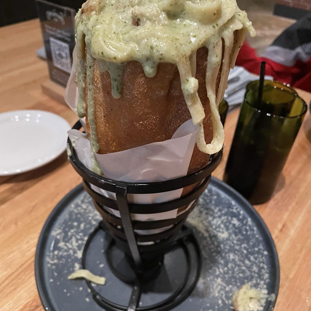The Operators Club - Pasta with mixed pesto and cream sauce. Served in a loaf of bread. - Sports Bars Near Me - Dallas, Texas The Operators Club - Pasta with mixed pesto and cream sauce. Served in a loaf of bread. - Sports Bars Near Me - Dallas, Texas