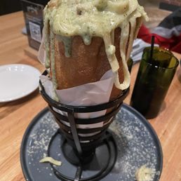Pasta with mixed pesto and cream sauce. Served in a loaf of bread. Pasta with mixed pesto and cream sauce. Served in a loaf of bread.