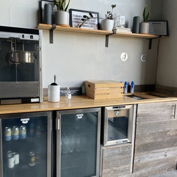 Aerodrome Distilling - a kitchen with a refrigerator and a coffee maker - Distilleries Near Me - Corpus Christi, Texas Aerodrome Distilling - a kitchen with a refrigerator and a coffee maker - Distilleries Near Me - Corpus Christi, Texas
