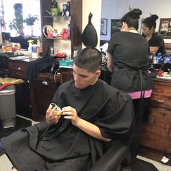 Crew Cuts Barber Shop - To focused on his darn toy !!!