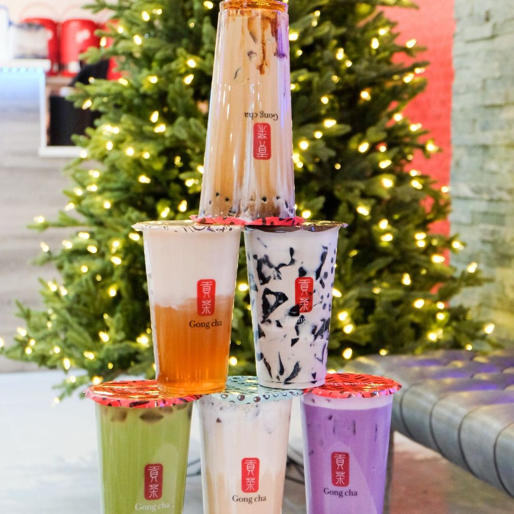 Gong cha - a stack of cups with drinks in front of a christmas tree - Bubble Tea Near Me - Surrey, British Columbia Gong cha - a stack of cups with drinks in front of a christmas tree - Bubble Tea Near Me - Surrey, British Columbia