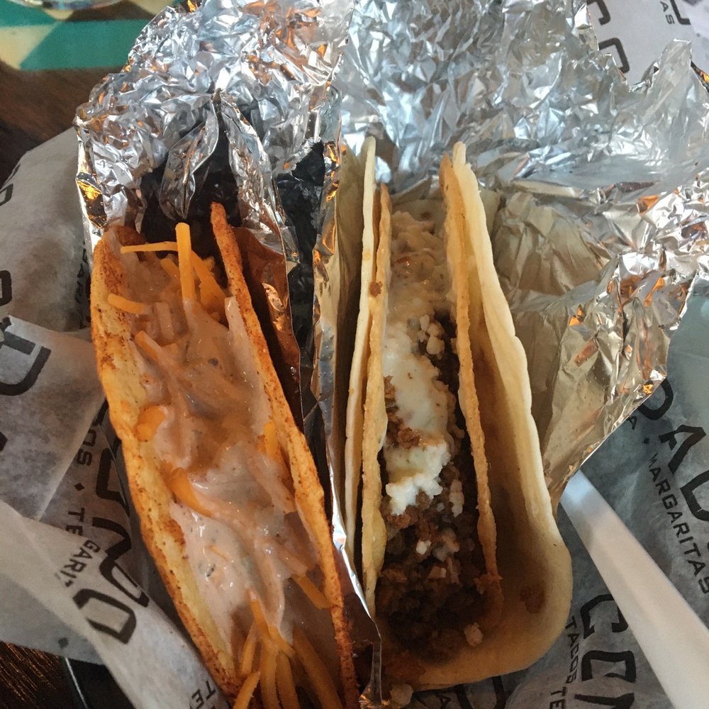 Condado Tacos - Left is chorizo, smoked cheddar, cilantro aioli on firecracker shell. Right is juju shell with ground beef and quest fresco. - Tacos Near Me - Indianapolis, Indiana Condado Tacos - Left is chorizo, smoked cheddar, cilantro aioli on firecracker shell. Right is juju shell with ground beef and quest fresco. - Tacos Near Me - Indianapolis, Indiana