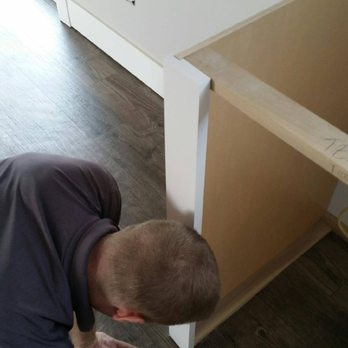 Floor It - a man bending over to look at something - Flooring Near Me Floor It - a man bending over to look at something - Flooring Near Me
