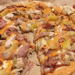 Chicken, pineapple, Canadian bacon, feta cheese, ricotta cheese and their Sriracha ranch sauce on top Chicken, pineapple, Canadian bacon, feta cheese, ricotta cheese and their Sriracha ranch sauce on top