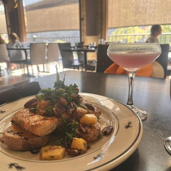 Canyon River Grill - Chargrilled Columbia River Salmon with roasted peaches and pecans, paired with the Purple Hoh-bo cocktail at Canyon River Grill. - New American Near Me - Ellensburg, Washington