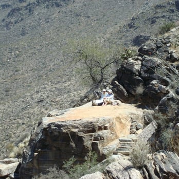Sabino Canyon - A couple relaxing on a rock along Telephone Line trail - Parks Near Me - Tucson, Arizona