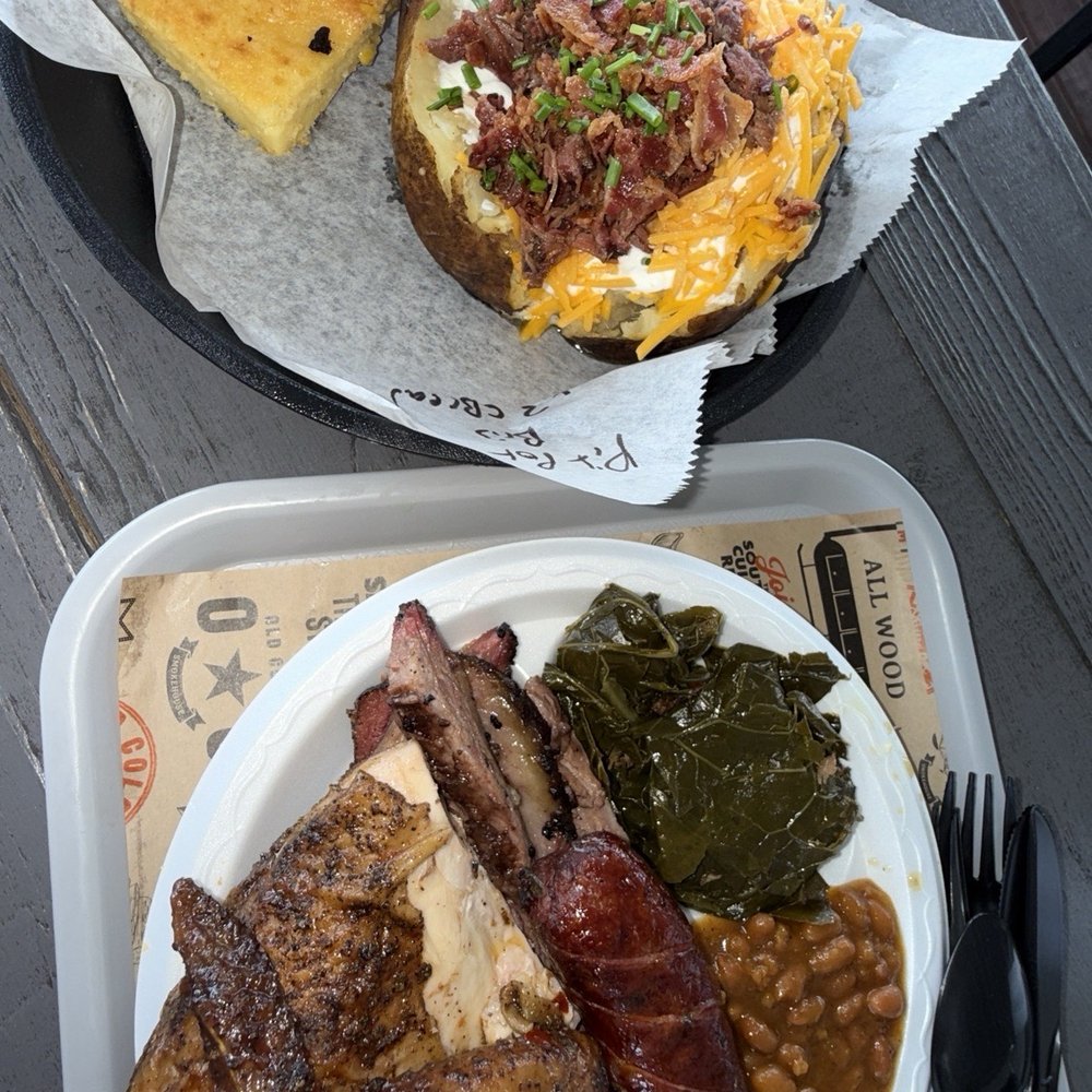 Old Colony Smokehouse - Loaded Pit Potato with brisket with corn bread 1/4 smoked chicken, brisket and jalapeño cheddar sausage link, collards and baked bean - Barbeque Near Me - Edenton, North Carolina Old Colony Smokehouse - Loaded Pit Potato with brisket with corn bread 1/4 smoked chicken, brisket and jalapeño cheddar sausage link, collards and baked bean - Barbeque Near Me - Edenton, North Carolina