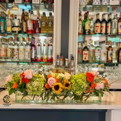Congers Florist - Small event centerpiece featuring sunflowers, roses, spray roses, hydrangea, and curly willow by Congers Florist.