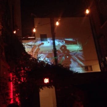 V26 - a movie projected on a building at night - Lounges Near Me - Riverside, California V26 - a movie projected on a building at night - Lounges Near Me - Riverside, California