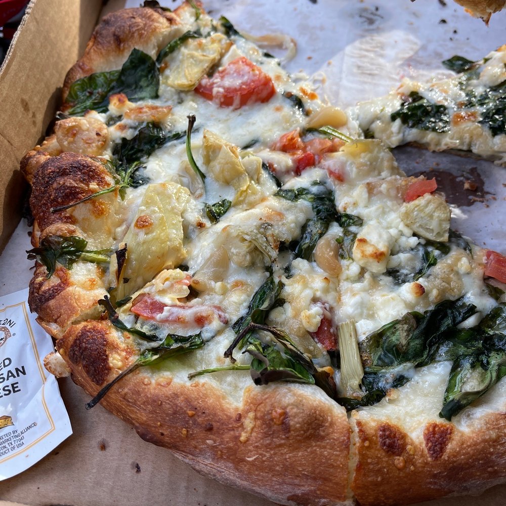 Pizza 101 - a pizza in a box with a slice taken out of it - Pizza Near Me - Keystone, Colorado Pizza 101 - a pizza in a box with a slice taken out of it - Pizza Near Me - Keystone, Colorado