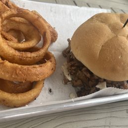 Brisket sandwich with slaw and onion rings Brisket sandwich with slaw and onion rings