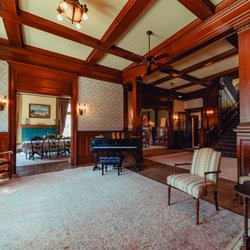 Alexander Mansion - Guests at the Alexander Mansion are greeted in the lovely entry foyer. Original carved wood accents set the tone for your event.