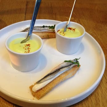 Pirouette - Amuse bouche - anchovy on top of cheese and bread with an egg yolk sauce - French Near Me - Paris, 75