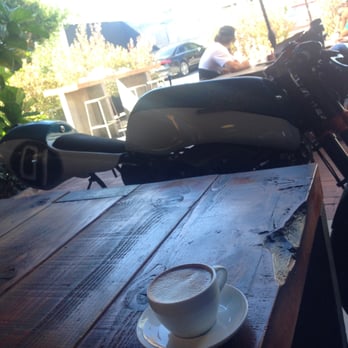 Deus Ex Machina - view from our table inside... looking outside at the patio! wouldn't be complete without the tableside motorcycle - Men's Clothing Near Me - Venice, California