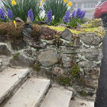 A1 On Time Construction LLC - BEFORE--right of stairs, eroded wall, stones missing - General Contractors Near Me