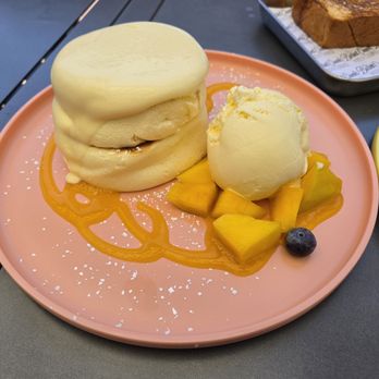 Burnt Crumbs - Mango creme souffle pancakes. - New American Near Me - Irvine, California