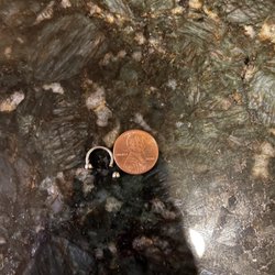 Every Body Tattoo - The septum jewelry next to a penny for size comparison. (Note that it is externally threaded)