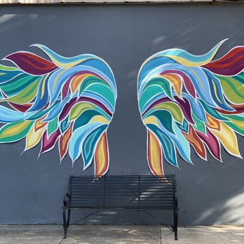 Old Iron Post - colorful wings painted on the side of a building - Bars Near Me - Sherman, Texas Old Iron Post - colorful wings painted on the side of a building - Bars Near Me - Sherman, Texas