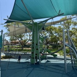 Intricate jungle gym with rope ladders, walkways, and climbing rungs