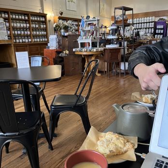 The Hawthorn Tree - a person sitting at a table with a laptop and a cup of coffee - Coffee & Tea Near Me - Cheyenne, Wyoming