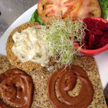 ChocolaTree - Veggie burger: homemade bean burger, ketchup, sautéed onions, fresh cabbage sauerkraut, tomato & lettuce served open face on seed bun. - Vegetarian Near Me - Sedona, Arizona ChocolaTree - Veggie burger: homemade bean burger, ketchup, sautéed onions, fresh cabbage sauerkraut, tomato & lettuce served open face on seed bun. - Vegetarian Near Me - Sedona, Arizona