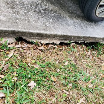 Atlantic Foundation And Concrete Repair - Runoff from the house's gutters stole way the ground along one side of the driveway slab. - Masonry/Concrete Near Me