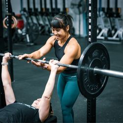 Iron Haven Fitness - Coach Snow Charpentier, Personal trainer, helping a client with bench press