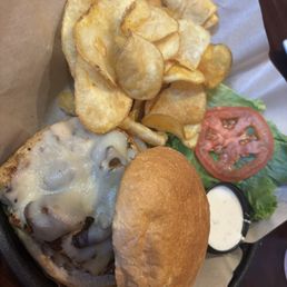 Chicken with mushrooms and Swiss with a side of hot chips Chicken with mushrooms and Swiss with a side of hot chips