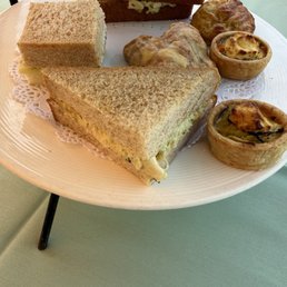 Savory plate with 2 chicken salad sando, missing salmon. Scone  incorrect. Pictured is a raspberry scone instead of rosemary.