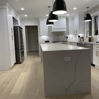 Bostonian Floor Company - a kitchen with a marble island - Flooring Near Me