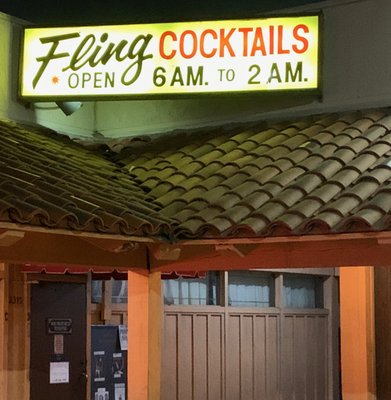Photo of The Fling - Santa Ana, CA, US. a neon sign above a closed door