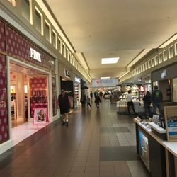 Valley River Center - Shoppers walk through a Valley River Center corridor near PINK and Macy's.