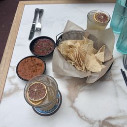 Chips, salsa, and bean dip. Enjoying it with a delicious margarita.