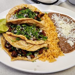 Taqueria El Viejon - Three tacos al pastor with rice and beans.
