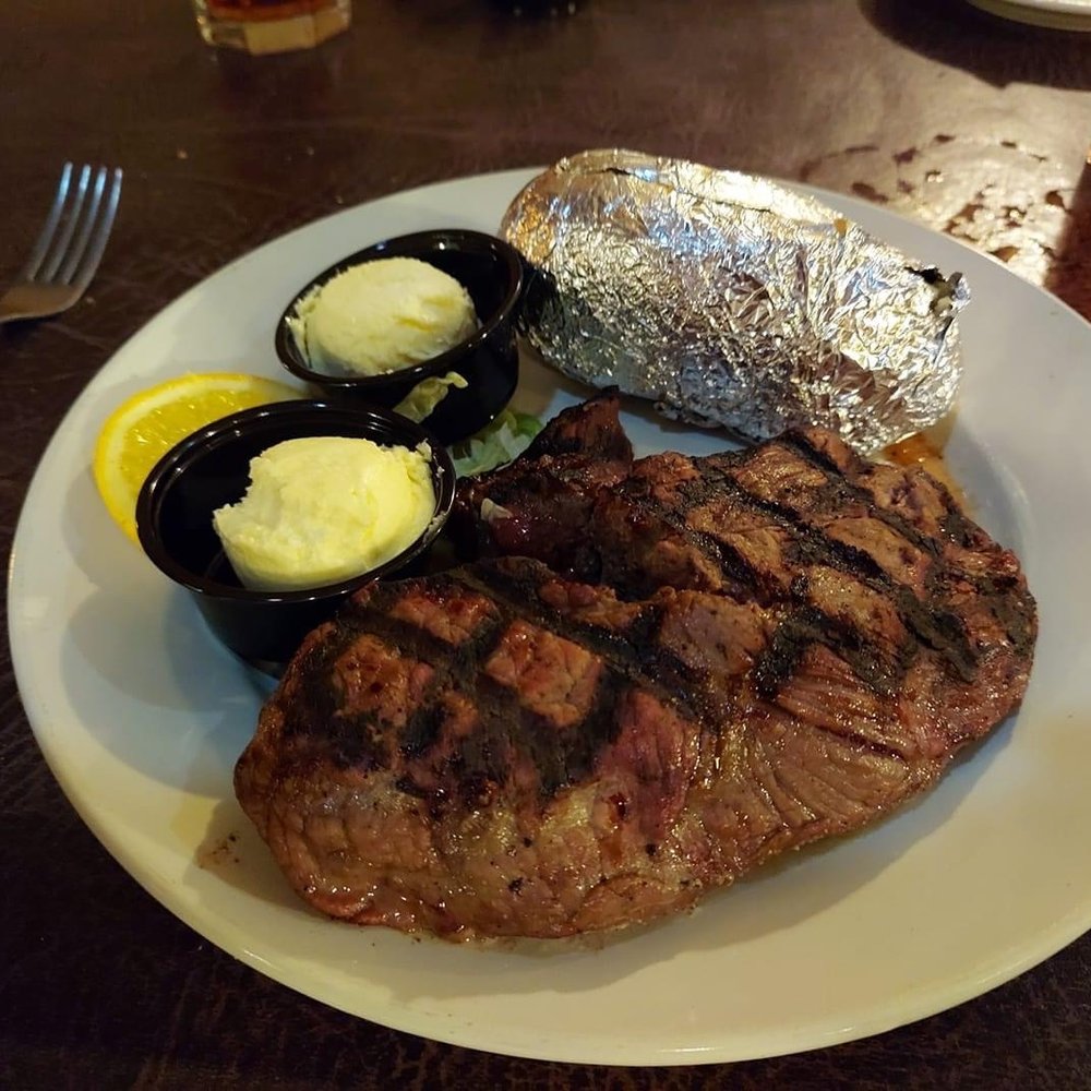 steak, potatoes, and butter on a plate