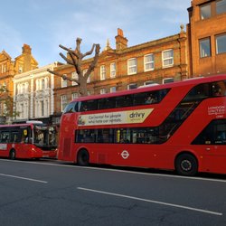 101 Thai Kitchen - Very English (London). Red double decker bus at the door of 101 Thai Kitchen.