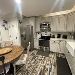 Sunny Days Vacation Rentals - Kitchen area. Kitchen was fully stocked. Washer, dryer, and bathroom located to the left. Entrance to cottage on the right.
