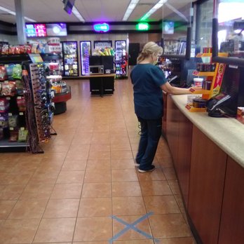 OnCue 129 - Standing on our taped "X" at the register - Gas Stations Near Me - Edmond, Oklahoma