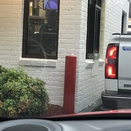 a white truck parked in front of a building a white truck parked in front of a building