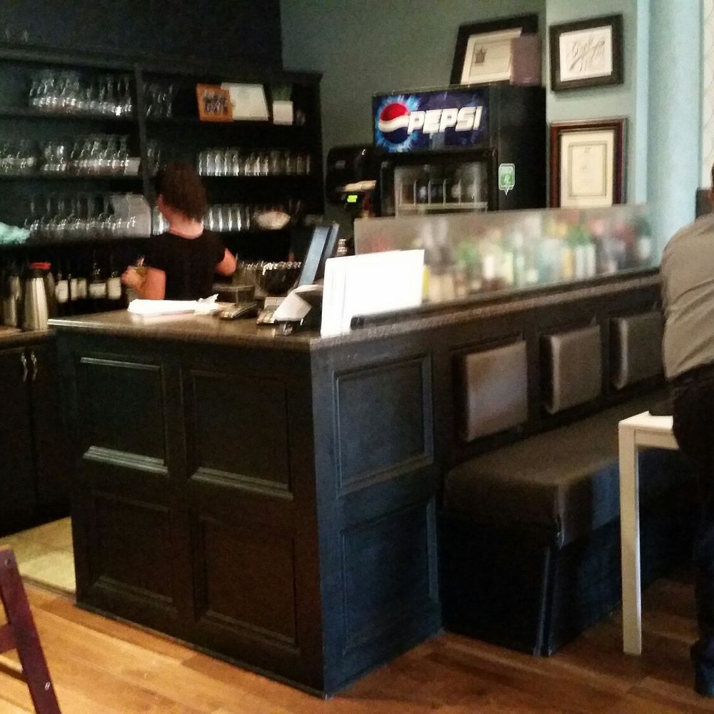 Black Spoon Bistro - a man standing at a bar - Seafood Near Me - North Sydney, Nova Scotia