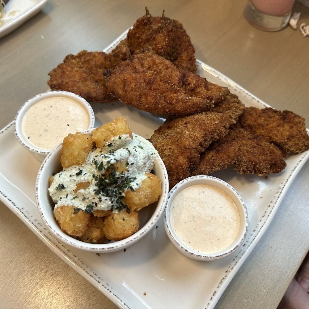 Tula's Kitchen - Large order of chicken strips with chipotle ranch, and a side of tater tots which come with a tzatziki drizzle - New American Near Me - Albuquerque, New Mexico Tula's Kitchen - Large order of chicken strips with chipotle ranch, and a side of tater tots which come with a tzatziki drizzle - New American Near Me - Albuquerque, New Mexico