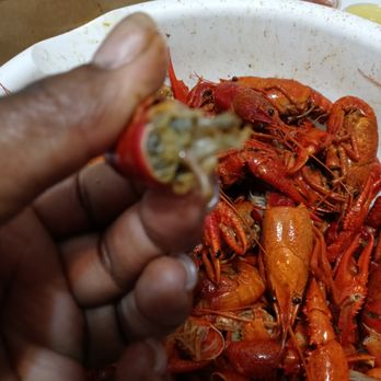 Louisiana Crawfish - a person holding a piece of crawfish - Seafood Near Me - Lake City, Georgia