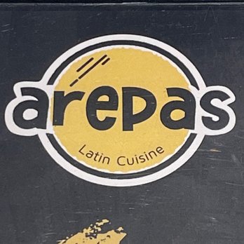 La Arepa - a black box with a yellow logo - Latin American Near Me - San Francisco, California La Arepa - a black box with a yellow logo - Latin American Near Me - San Francisco, California