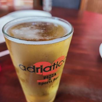 Adriatico's - a glass of beer on a table - Pizza Near Me - Cincinnati, Ohio Adriatico's - a glass of beer on a table - Pizza Near Me - Cincinnati, Ohio