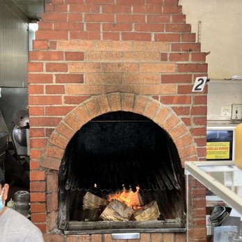Pollo Ala Brasa - a man wearing a face mask in front of a brick oven - Peruvian Near Me - Gardena, California Pollo Ala Brasa - a man wearing a face mask in front of a brick oven - Peruvian Near Me - Gardena, California