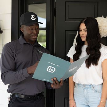 Hawx Pest Control - Hawx technician reviews service details with customer at her doorstep, ensuring clear communication and peace of mind. - Pest Control Near Me - West Chicago, Illinois